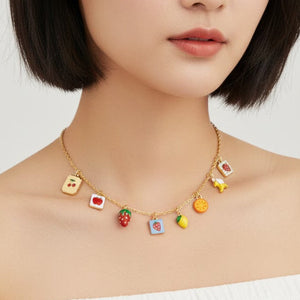 Necklace with colorful fruit charms worn by a model on a white background